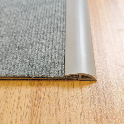 Close-up of 6.6 Ft Long Floor Transition Strip Edge Reducer for Rubber Wood Tile and Carpet Floors Beveled Ramp Threshold Edging Vinyl Trim