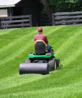 Person using Tow Behind Lawn Roller 690 Lb Capacity With Easy Turn Plug, 36 Inch Wide Poly Drum, Flat Black Finish on large lawn