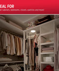 Tap Light Battery Operated Soft White Wireless Puck Light illuminating a closet, showcasing clothes storage and organization.