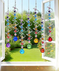 Seven Piece Crystal Gazing Ball Spiral Wind Spinner Suncatchers For Garden Decor, Durable Metal Frame With K9 Crystal Prisms, Cool Colorful Outdoor Yard Ornaments That Catch Sunlight And Spin In The Breeze. Hanging window view of seven spiral crystal wind spinners with colored glass drops