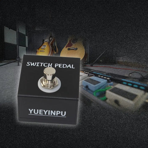 Tap Switch Pedal For Guitar Effects Latch Footswitch With 1/4 Inch TS Cable in a studio setup with guitars in the background
