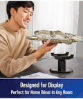 Person displaying Millennium Falcon 3D Model Kit For Star Wars Fans And Collectors, perfect desk decor and dope build puzzle.
