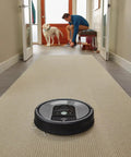 Robot vacuum cleaning a carpeted hallway, showcasing Replacement Kit for 800 and 900 Series Robot Vacuums with 3 AeroForce Filters.