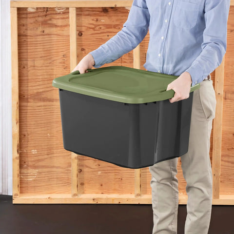 Person holding Heavy Duty 17.5 Gallon Plastic Storage Bin With Clear Lid And Full Length Through Wall Handles Gray Opaque Base.