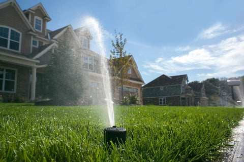 Tough As Nails Gear Drive Pop Up Lawn Sprinkler Boasting Preinstalled Number 6 Nozzle spraying across lush green lawn.