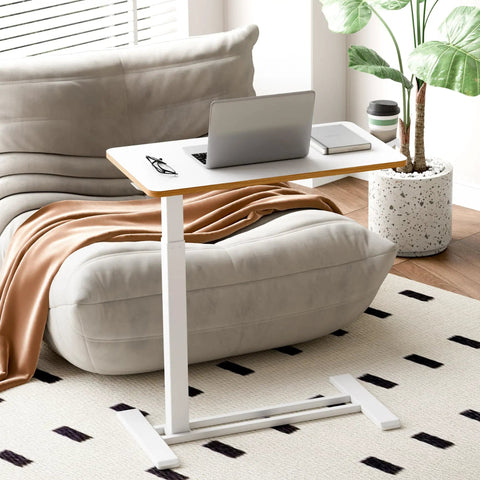 Overbed Table With Pneumatic Lift, Adjustable Height 26 To 41.7 Inches, Hidden Casters, used as mobile laptop desk by sofa