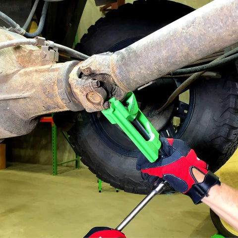 Beefy Heavy Duty U Joint Puller for Intermediate Trucks Buses and Farm Equipment in use on a vehicle driveshaft