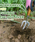 Heavy Duty Weeding Fork With Sharp Tines And Comfortable Wood Handle For Fast Weed Uprooting, shown loosening soil