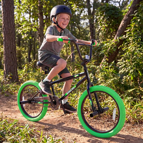 Child riding 20 Inch Freestyle BMX Bike for Beginners With 360 Degree Handlebar, 4 Pegs, U Brake in green, forest path.