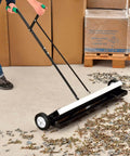 Built Different Heavy Duty 36 Inch Floor Magnetic Sweeper With Quick Release Lever For Warehouses And Shop Floors Picks Up Steel Scrap And Hardware Cleanup Rocks in use on workshop floor.