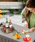 Outdoor rolling cooler with stainless steel lid, showing use in backyard setting slicing fruit, drinks on the side.