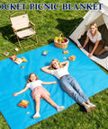 Family relaxing on Sandproof Waterproof Pocket Picnic Blanket With Corner Pockets And Stakes Ultra Compact Quick Dry Beach Mat