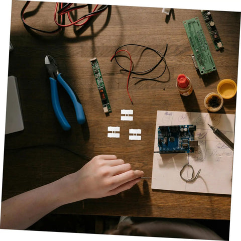 Hand arranging electronics on table with 80Pcs Spring Clamp Terminal Connectors For LED Lighting Quick Connection Barrier Blocks