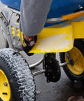 Close-up of Spyker Winter Weather Deicing Kit With Ergo Pro 50 Pound Spreader in snowy conditions, showing stainless steel agitator.