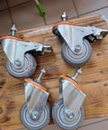 5 Inch Heavy Duty Castor Wheels With TPR Swivel Base, M12x30mm Threaded Stem, Dead Silent Roll, Floor Savers Rubber Tread, Set Of Four Industrial Casters on wooden surface.