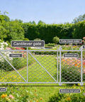 Cantilever gate with chain link fence, tube track roller, latch post, and labeled balance bars in a garden setting.