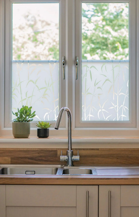 Privacy Window Film Bamboo Pattern Reusable Static Cling For Glass Surfaces installed on kitchen windows with plants nearby