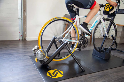 Cyclist using Indoor Trainer Tire for Road Bikes 700x25c Yellow, Ultra Quiet and Durable, Indoors-Only Use during home spin session