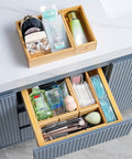 Bamboo Drawer Organizer Set Of 9 For Kitchen And Office in use, organizing cosmetics and toiletries in bathroom drawer.