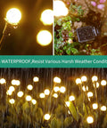 80 LED Solar Outdoor Lights 10 Pack Waterproof Garden Decor with warm white glow in rain on patio lawn, close-up view.
