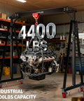 Built Like A Tank Adjustable Gantry Crane 2 Ton 4400 Lbs Capacity lifting an engine in a workshop on a mobile frame.