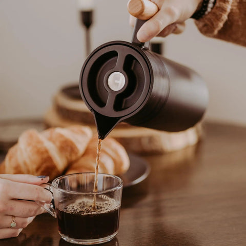 Pouring coffee from 40 Oz Thermal Coffee Carafe With Tea Infuser Stainless Steel Double Walled Vacuum Insulated Beverage Dispenser