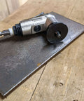 Side view of pneumatic air chamfer tool with silver body and round deburring disc