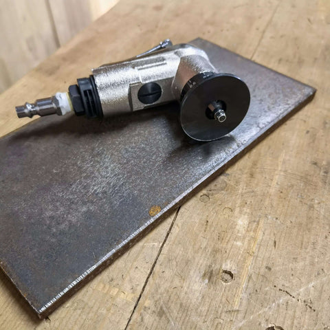 Side view of pneumatic air chamfer tool with silver body and round deburring disc