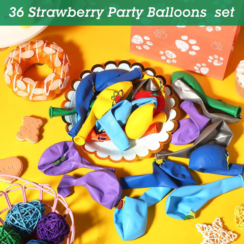 Colorful assortment of latex balloons on a table, part of a 36 Strawberry Party Balloons set.