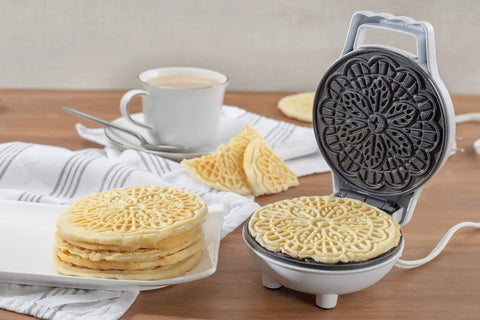 Cute Mini Electric Pizzelle Maker creates single 4 inch Italian waffle cookies with nonstick plates and compact design.