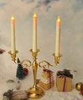 LED Taper Candles With Remote Control, Rechargeable Amber Glow, 6 Pack displayed on golden candelabra with holiday decor