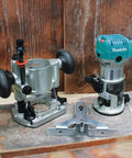 Beefy One And One Quarter Horsepower Compact Router Kit With Variable Speed From 10000 To 30000 RPM Rack And Pinion Fine Depth Adjustment Slim Ergonomic Body And Quick Release Cam Lock For Precise Comfortable Woodworking, showing motor and base unit on wooden surface.