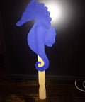 Blue seahorse shape on a wood stir stick from American-Made Basswood Paint Stir Sticks 21 Inch Bulk 250 Count for art projects.