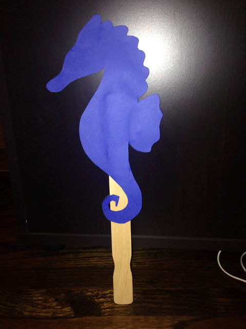 Blue seahorse shape on a wood stir stick from American-Made Basswood Paint Stir Sticks 21 Inch Bulk 250 Count for art projects.