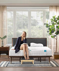 Woman sitting on bed with Sturdy Wooden Step Stool For Adults And Seniors With Non Slip Rubber Tread, 5.5 Inch Rise.