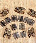 5 Pack Snap Latch Sliding Door Gate Cabinet Furniture Jewelry Box Screws set of metal hinges on wood surface.