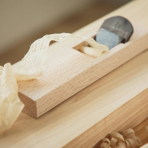 Japanese Kanna Manual Hand Plane For Smoothing Woodwork with 42mm steel blade on wood surface producing shavings.