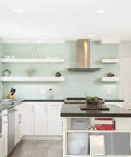 Top Shelf 6 Inch LED Recessed Downlights With Adjustable Color Temperature illuminating a modern kitchen with light green tiles.