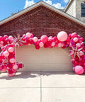 60 Piece Pink Balloons Set With 12 Inch Latex Balloons In Macaron Pink, Hot Pink, Pastel, Metallic, Matte, And Confetti Styles Plus 10m Pink And 10m Hot Pink Ribbons For Birthday Parties, Baby Showers, Weddings, And Girls Night displayed in arch over garage.