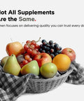 Basket of assorted fruits including pears, apples, grapes, and oranges with a patterned cloth.