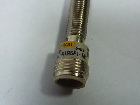 Inductive Proximity Sensor With 1.5 Millimeter Sensing Range PNP Output And 10 To 40 V DC Supply Cylindrical Housing RoHS Compliant Model E2E X1R5F1 M1 Proximity Sensor For Industrial Automation showing cylindrical metal body.