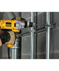 Corded Hammer Drill Kit With Half Inch Capacity And Ten Amp Power For Masonry Wood And Steel Drilling Dual Mode Hammer And Drill Built For Pros And Serious DIYers Who Need Beefy Power being used on masonry wall