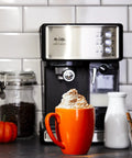 Three In One Espresso And Cappuccino Machine With Stainless Steel Body Programmable Coffee Maker on kitchen countertop with orange mug