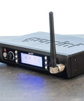 Dual UHF Wireless Handheld Microphone System with Two Mics receiver unit on a table, showing antennas and control panel.