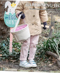 Child holding Dual Head Cultivator Garden Hoe For Lightweight Outdoor Yard Work Portable Sturdy Metal Garden Tool, dressed for gardening.