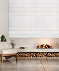 Living room with white wall panels above a modern fireplace, showcasing 3D Wall Panels Peel And Stick Waterproof Faux Stone.