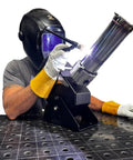 Person using Heavy Duty Compact Rotary Welding Positioner Turntable with TIG welder, gloves and protective gear.