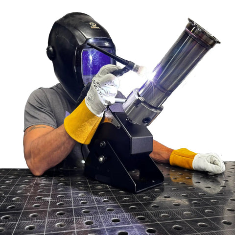 Person using Heavy Duty Compact Rotary Welding Positioner Turntable with TIG welder, gloves and protective gear.