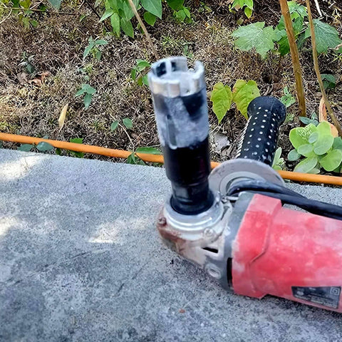 Mostartools 1-1/4 inch dry diamond core drill bit for granite mounted on a red angle grinder