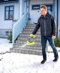 Man using OSS1800 Salt Spreader For Yard And Garden Semi Battery 18V One Plus on snowy steps, spreading salt effectively